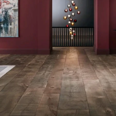 Dark wooden floored gallery room with picture and bauble installation