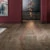 Dark wooden floored gallery room with picture and bauble installation
