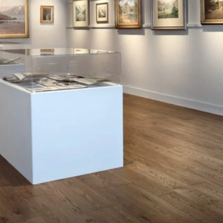 Gallery with paintings on the walls and a perspex-covered table with documents inside it