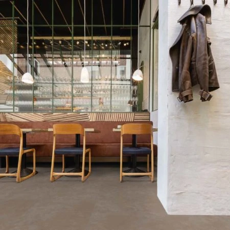 Row of chairs at a bar and coat hanging on wall