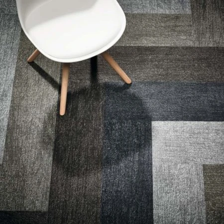 Close up of white chair and grey office carpet