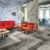 Modern breakout area with grey flooring and red chairs
