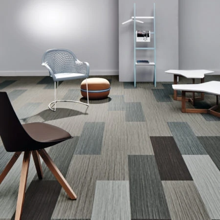 Random chairs displayed on a grey office floor