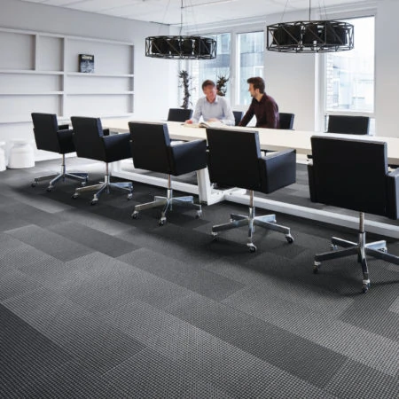 White boardroom with black chairs around a large table