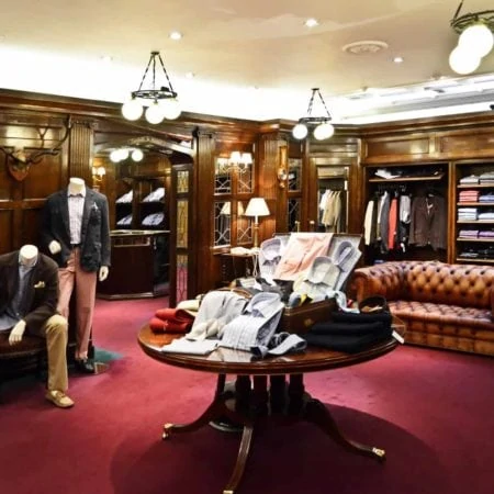 Inside posh gentlemen's clothing shop with rich red carpet