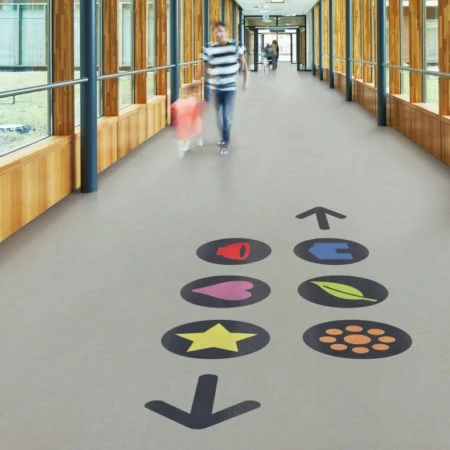 Father and child walking down a school corridor