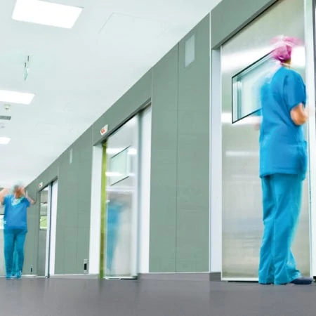 Nurses walking along hospital corridoor