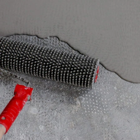 Newly-poured screed on concrete floor with smoothing rake