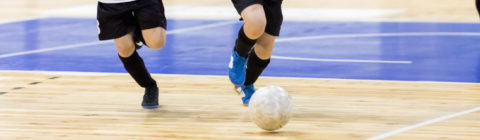 Kids playing with ball on wooden floor