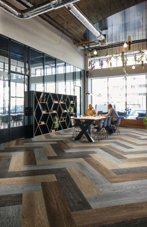 Large industrial-style office with long table and shelves