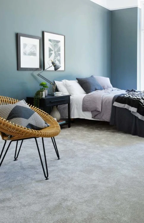 Bedroom with bed, blue walls and grey Cormar carpet