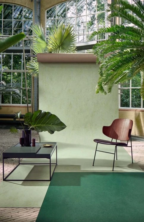 Green roll of vinyl flooring with leafy plants