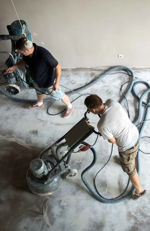 Men polishing sub-floor